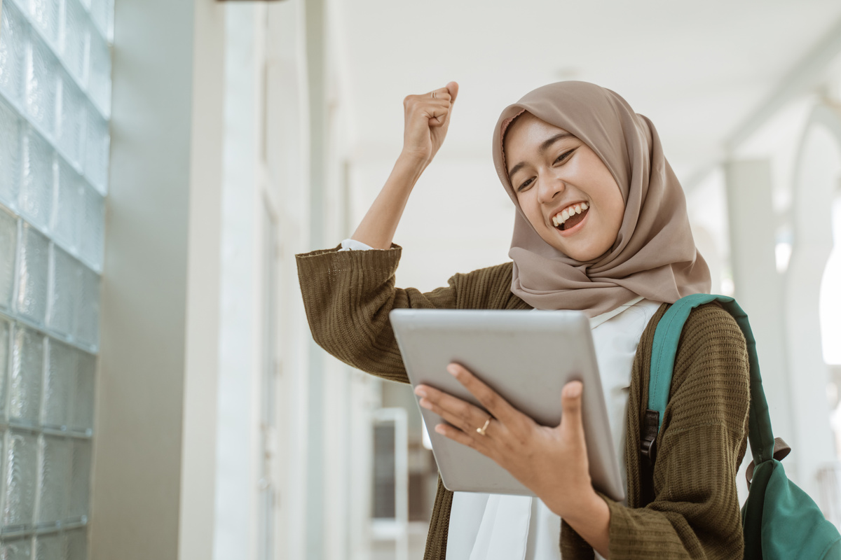 Portrait Happy Muslim Female Student Holding a Tablet