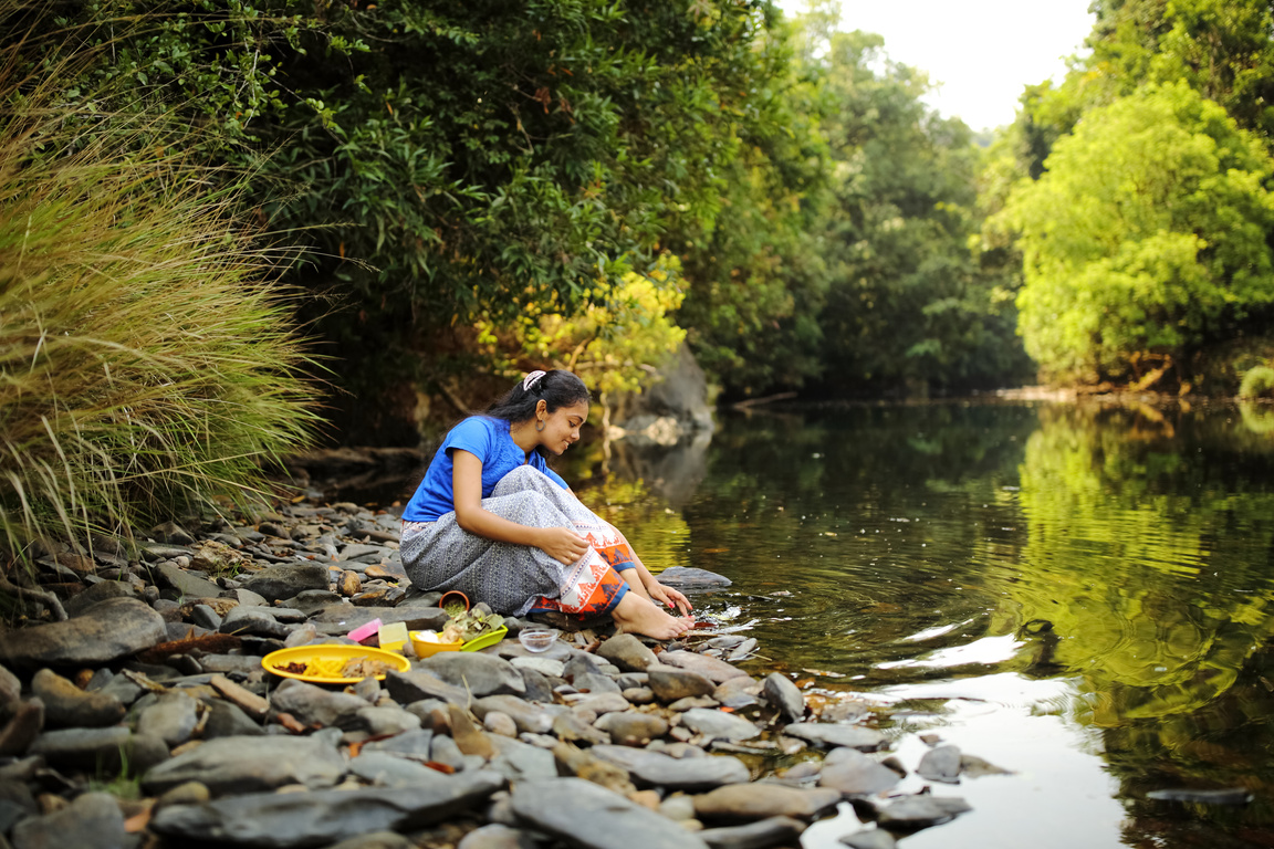 Female Herbalist Playing in River Water