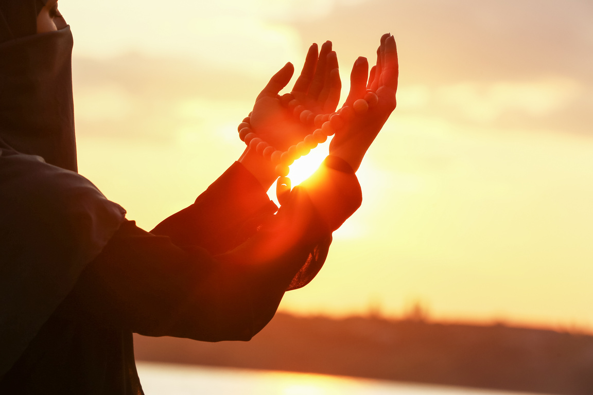 Beautiful Muslim Woman Praying Outdoors at Sunset