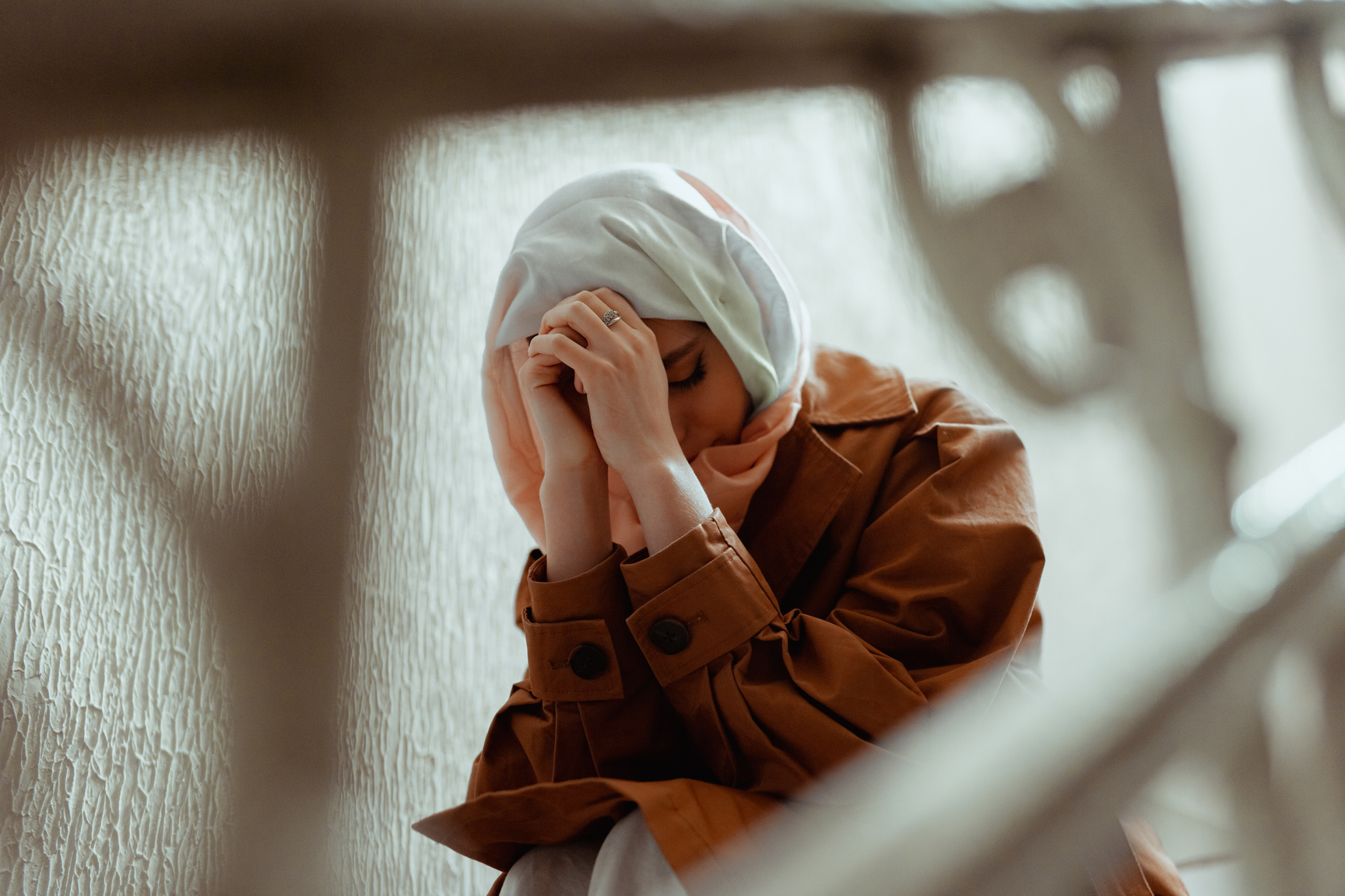 A Woman Sitting with Her Hands Together 