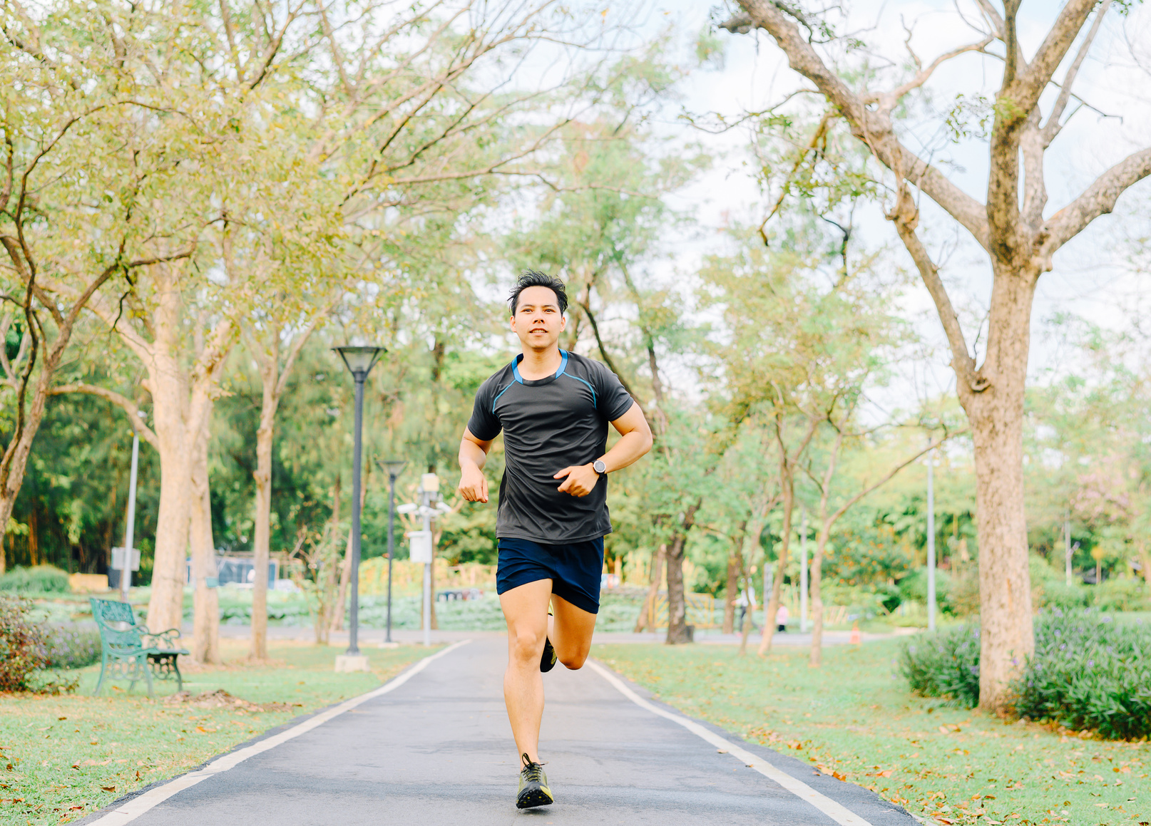 Healthy Asian Man Running in the Park in Morning